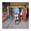 1970s Two Women Small Girl Walking Down Supermarket Grocery Store Aisle Woman Pushing Cart by Anonymous