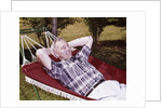 1960s Older Man Lying In Hammock In Backyard Retired Lifestyle Leisure by Anonymous