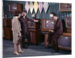 1960s Couple Man Woman Talking To Salesman In Color Television Set Sales Department by Anonymous