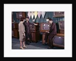 1960s Couple Man Woman Talking To Salesman In Color Television Set Sales Department by Anonymous