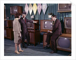 1960s Couple Man Woman Talking To Salesman In Color Television Set Sales Department by Anonymous