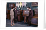 1960s Couple Man Woman Talking To Salesman In Color Television Set Sales Department by Anonymous