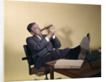 1960s Successful Businessman With Look Of Satisfaction Sitting With Shoes Propped On Desk by Anonymous