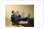 1960s Successful Businessman With Look Of Satisfaction Sitting With Shoes Propped On Desk by Anonymous