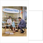 1960s 1970s Mother Watching Salesman Fit Shoes On Daughter In Shoe Section Of Department Store by Anonymous