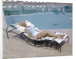1960s Elegant Tall Woman In Bathing Suit Reclining On A Lounge Chair By Swimming Pool by Anonymous