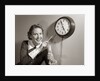 1950s Woman Holding Steno Pad Pointing With Pencil To Clock 5 Minutes Till Quitting Time by Anonymous