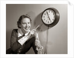 1950s Woman Holding Steno Pad Pointing With Pencil To Clock 5 Minutes Till Quitting Time by Anonymous