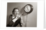1950s Woman Holding Steno Pad Pointing With Pencil To Clock 5 Minutes Till Quitting Time by Anonymous