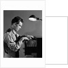 1940s Young Man Office File Clerk Putting Records Into Filing Cabinet Drawer by Anonymous