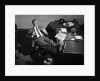 1950s Man Businessman Salesman Eating Lunch In Office With Feet Resting Up On Desk by Anonymous