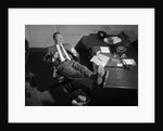 1950s Man Businessman Salesman Eating Lunch In Office With Feet Resting Up On Desk by Anonymous