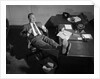 1950s Man Businessman Salesman Eating Lunch In Office With Feet Resting Up On Desk by Anonymous