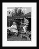 1960s Boy Playing Guitar, Woman Holding Soft Drink Bottle Outside In Backyard by Anonymous