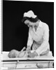 1940s Woman Nurse Changing Baby Diaper In Nursery by Anonymous
