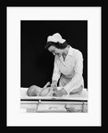 1940s Woman Nurse Changing Baby Diaper In Nursery by Anonymous