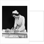 1940s Woman Nurse Changing Baby Diaper In Nursery by Anonymous