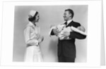 1930s 1940s Woman Nurse Talking With Man Proud New Father Holding Newborn Twin Babies by Anonymous