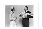 1930s 1940s Woman Nurse Talking With Man Proud New Father Holding Newborn Twin Babies by Anonymous