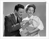1950s 1960s Man New Father Looking At Baby Held By Woman Nurse by Anonymous
