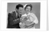 1950s 1960s Man New Father Looking At Baby Held By Woman Nurse by Anonymous