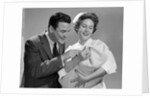 1950s 1960s Man New Father Looking At Baby Held By Woman Nurse by Anonymous