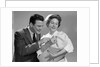 1950s 1960s Man New Father Looking At Baby Held By Woman Nurse by Anonymous