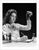 1940s Student Nurse Holding Up Test Tube While Taking Notes In Science Class by Anonymous