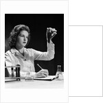 1940s Student Nurse Holding Up Test Tube While Taking Notes In Science Class by Anonymous