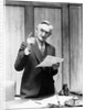 1930s Elderly Man In Office Standing Behind Desk Gesturing With Raised Finger by Anonymous