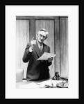 1930s Elderly Man In Office Standing Behind Desk Gesturing With Raised Finger by Anonymous