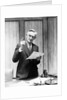 1930s Elderly Man In Office Standing Behind Desk Gesturing With Raised Finger by Anonymous