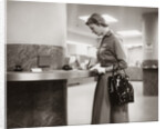 1950s 1960s Woman Handbag On Arm Gloves Filling Out Deposit Slip Bank Counter by Anonymous