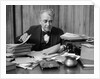1920s 1930s Elderly Executive Man Sitting At Desk Looking Through Papers by Anonymous