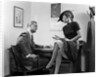 1940s Woman Sitting On Desk Hat Skirt Hand Gesture Talking Flirting With Man by Anonymous
