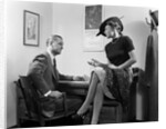 1940s Woman Sitting On Desk Hat Skirt Hand Gesture Talking Flirting With Man by Anonymous
