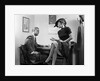 1940s Woman Sitting On Desk Hat Skirt Hand Gesture Talking Flirting With Man by Anonymous