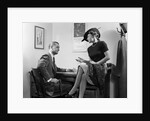 1940s Woman Sitting On Desk Hat Skirt Hand Gesture Talking Flirting With Man by Anonymous