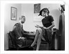 1940s Woman Sitting On Desk Hat Skirt Hand Gesture Talking Flirting With Man by Anonymous