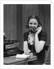 1930s Woman Receptionist Secretary Sitting At Desk In Office Talking On Telephone by Anonymous