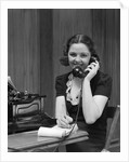 1930s Woman Receptionist Secretary Sitting At Desk In Office Talking On Telephone by Anonymous