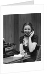 1930s Woman Receptionist Secretary Sitting At Desk In Office Talking On Telephone by Anonymous