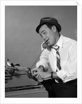 1960s Reporter With Hat On Phone At Typewriter by Anonymous