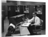 1960s Man In Shirt Tie and Thick Black Glasses Working With IBM Data Processing System by Anonymous