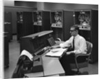 1960s Man In Shirt Tie and Thick Black Glasses Working With IBM Data Processing System by Anonymous