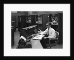 1960s Man In Shirt Tie and Thick Black Glasses Working With IBM Data Processing System by Anonymous