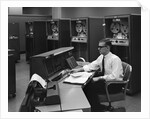 1960s Man In Shirt Tie and Thick Black Glasses Working With IBM Data Processing System by Anonymous