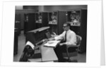 1960s Man In Shirt Tie and Thick Black Glasses Working With IBM Data Processing System by Anonymous