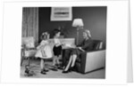 1950s Little Boy And Girl Son And Daughter Giving Woman Mother Sitting In Living Room A Gift Present by Anonymous