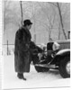 1930s Man In Hat And Raccoon Fur Coat Standing Foot On Bumper Of Chevrolet Roadster Stalled In Snow Storm by Anonymous
